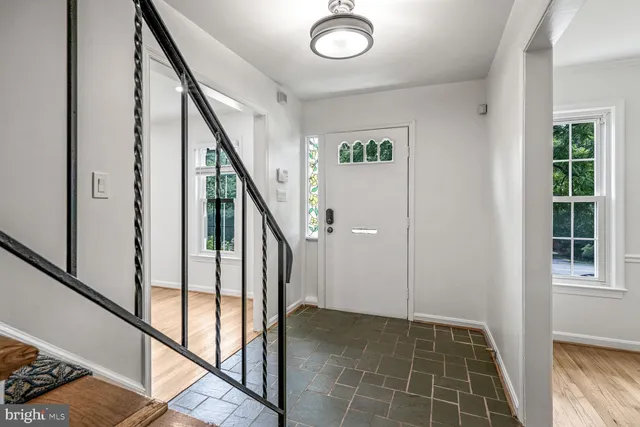 a view of an entryway with wooden floor and stairs