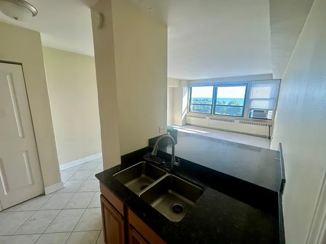 a kitchen that has a sink a refrigerator and a stove
