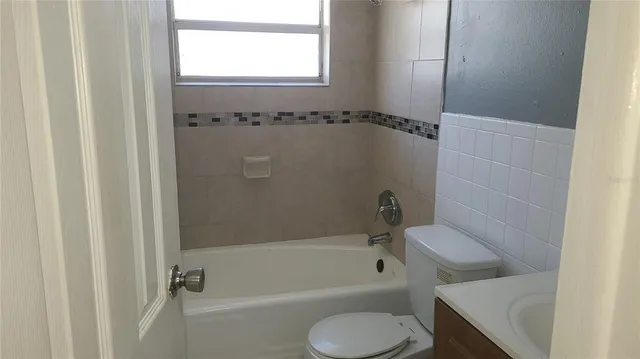 a bathroom with a shower and a toilet