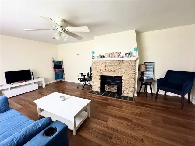 a living room with furniture and a fireplace