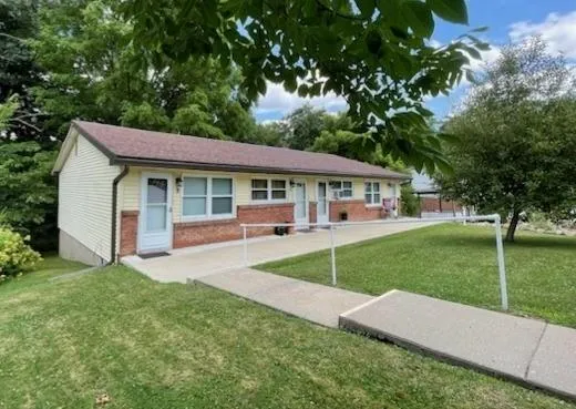 a view of a house with a backyard and a patio