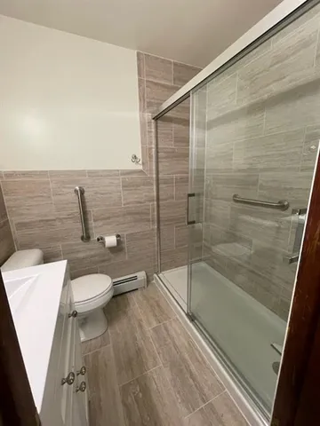 a bathroom with a toilet and a shower