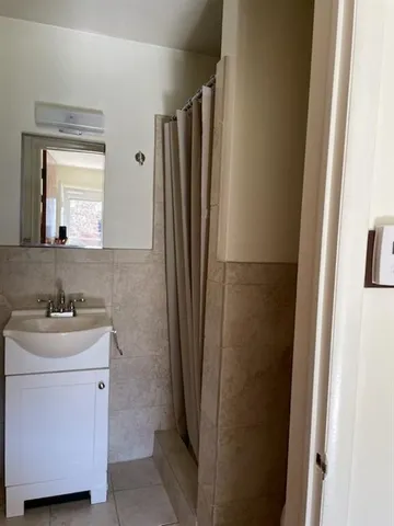 a bathroom with a sink a toilet a mirror and vanity