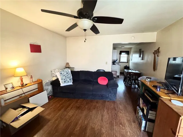 a view of a workspace with furniture and a flat screen tv