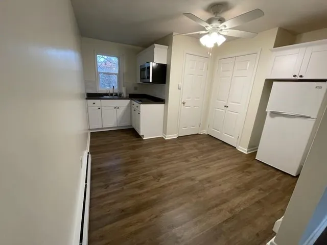 a view of a kitchen with a sink and a refrigerator