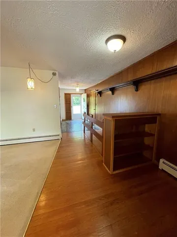 a room with wooden floor and furniture