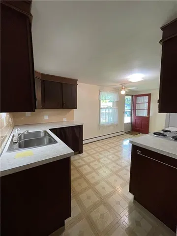 a kitchen with a sink stove and microwave