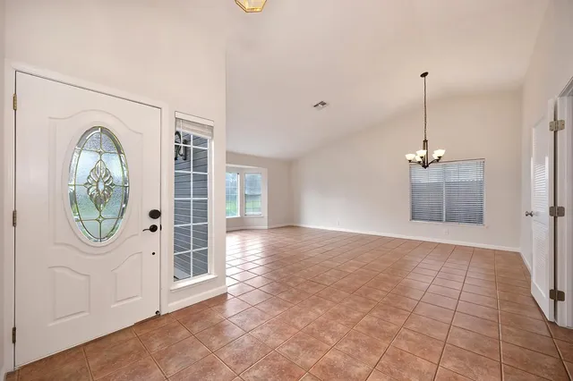 a view of a room with wooden floor and a window
