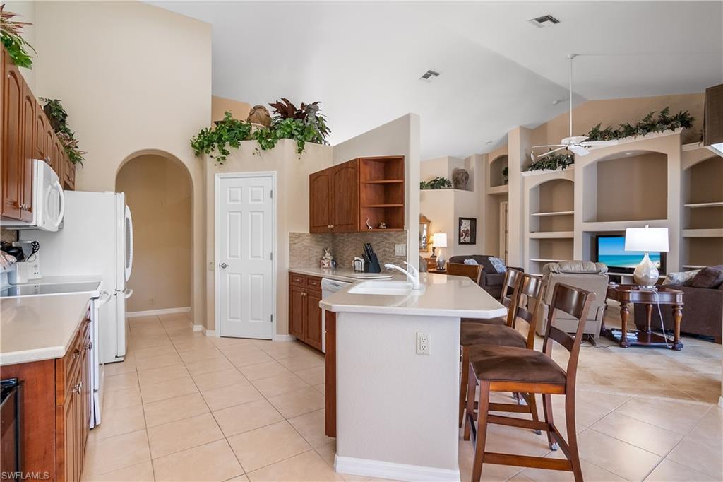 8931 Lely Island Circle Naples, FL 34113 - Photo 16 of 46 a view of a kitchen with furniture and a kitchen