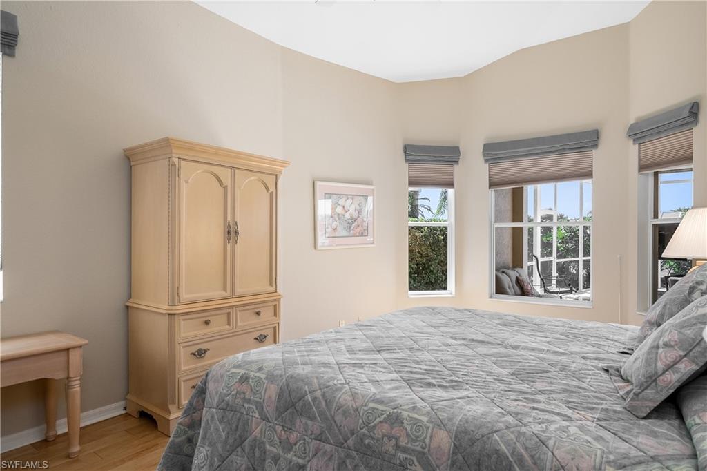 8931 Lely Island Circle Naples, FL 34113 - Photo 21 of 46 a large bedroom with a bed and wooden floor