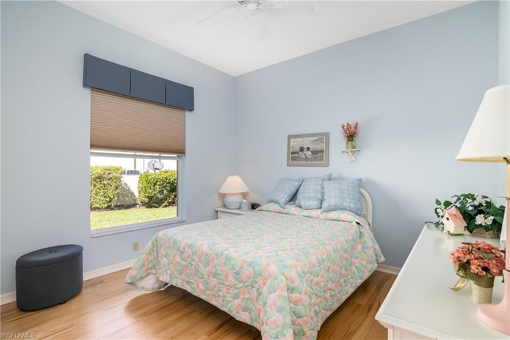 8931 Lely Island Circle Naples, FL 34113 - Photo 26 of 46 a bedroom with a bed and a dresser next to a window