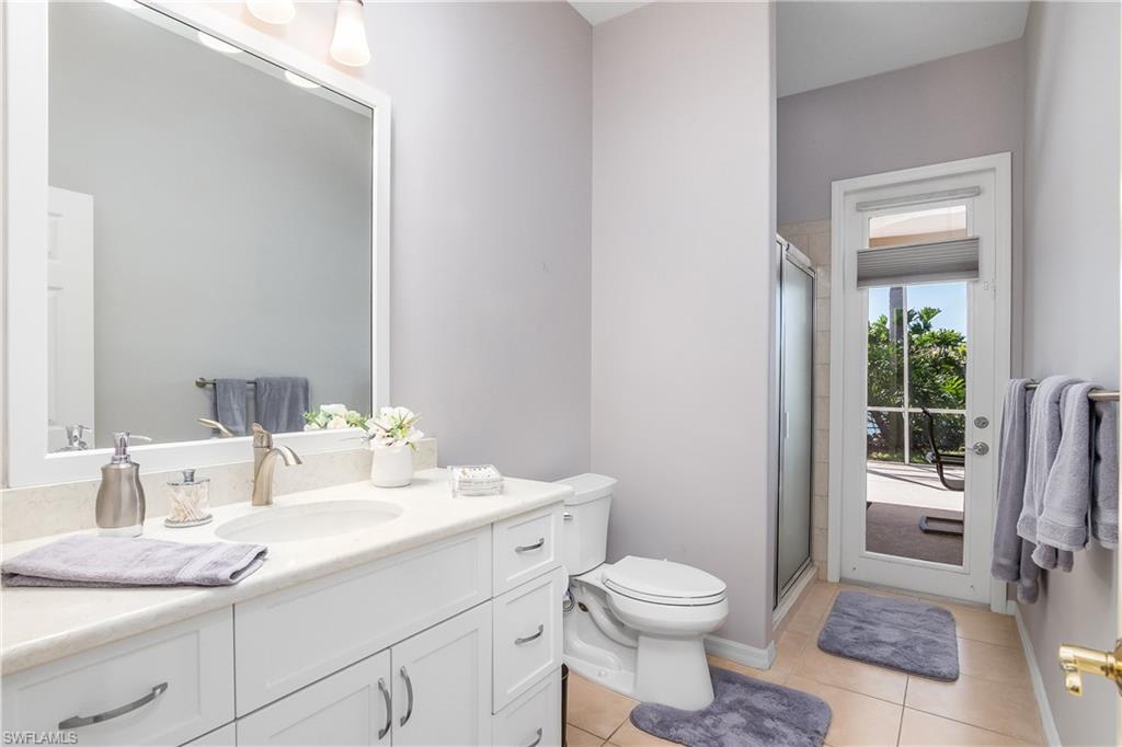 8931 Lely Island Circle Naples, FL 34113 - Photo 27 of 46 a bathroom with a granite countertop sink toilet and shower