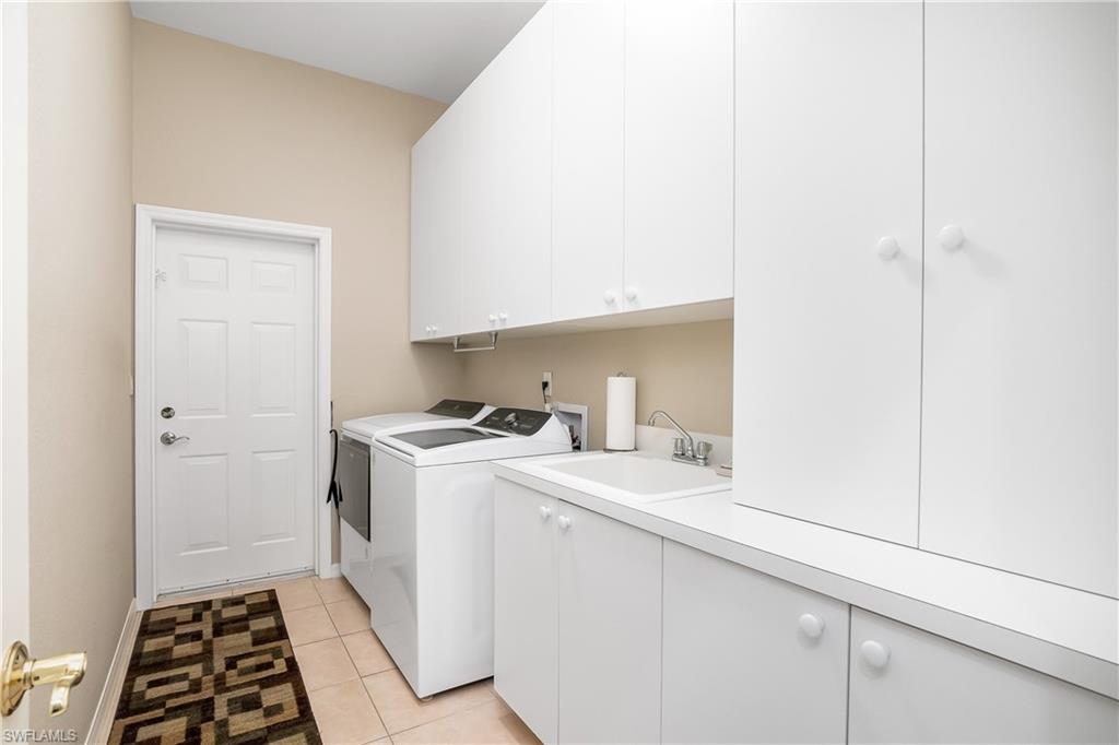 8931 Lely Island Circle Naples, FL 34113 - Photo 28 of 46 a room with a washer and dryer