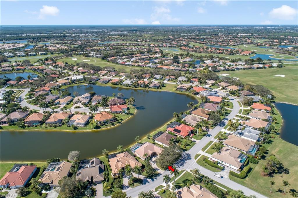 8931 Lely Island Circle Naples, FL 34113 - Photo 3 of 46 an aerial view of lake and residential houses with outdoor space