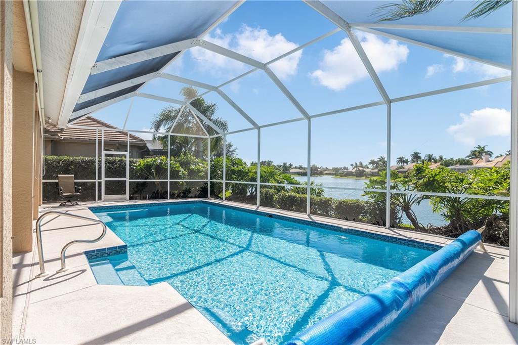 8931 Lely Island Circle Naples, FL 34113 - Photo 35 of 46 a view of a living room and floor to ceiling window