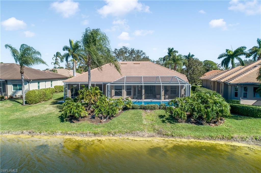 8931 Lely Island Circle Naples, FL 34113 - Photo 5 of 46 a aerial view of a house with swimming pool and a yard