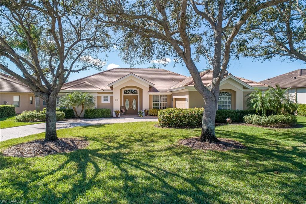 8931 Lely Island Circle Naples, FL 34113 - Photo 7 of 46 a front view of a house with yard and green space
