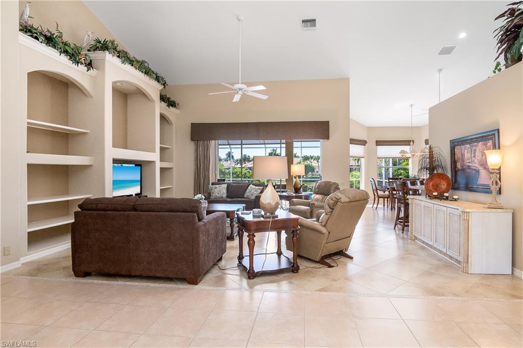 8931 Lely Island Circle Naples, FL 34113 - Photo 8 of 46 a living room with furniture and a fireplace
