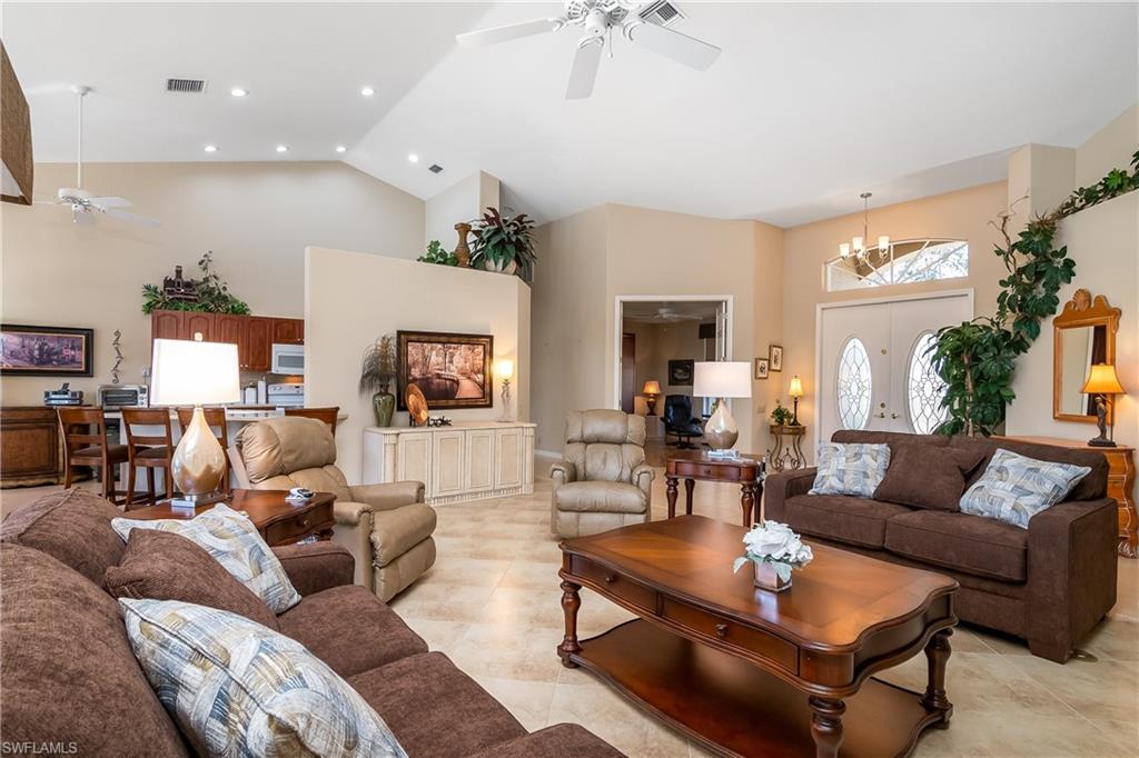 8931 Lely Island Circle Naples, FL 34113 - Photo 10 of 46 a living room with furniture and a fireplace