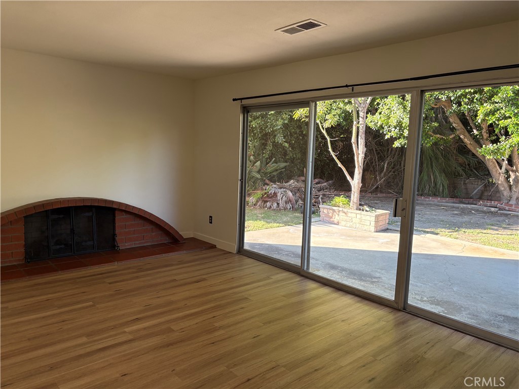 1941 Hillhaven Drive Brea, CA 92821 - Photo 6 of 30 a view of empty room with wooden floor and floor to ceiling window