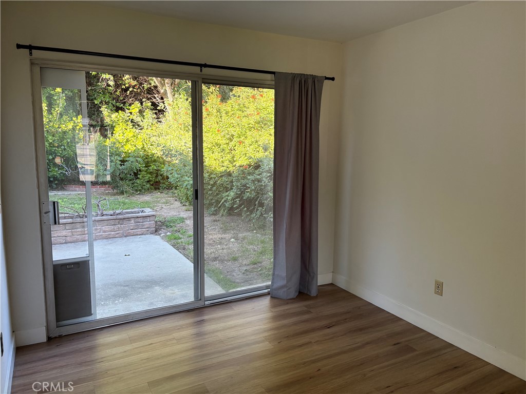 1941 Hillhaven Drive Brea, CA 92821 - Photo 9 of 30 a view of an empty room with wooden floor and windows