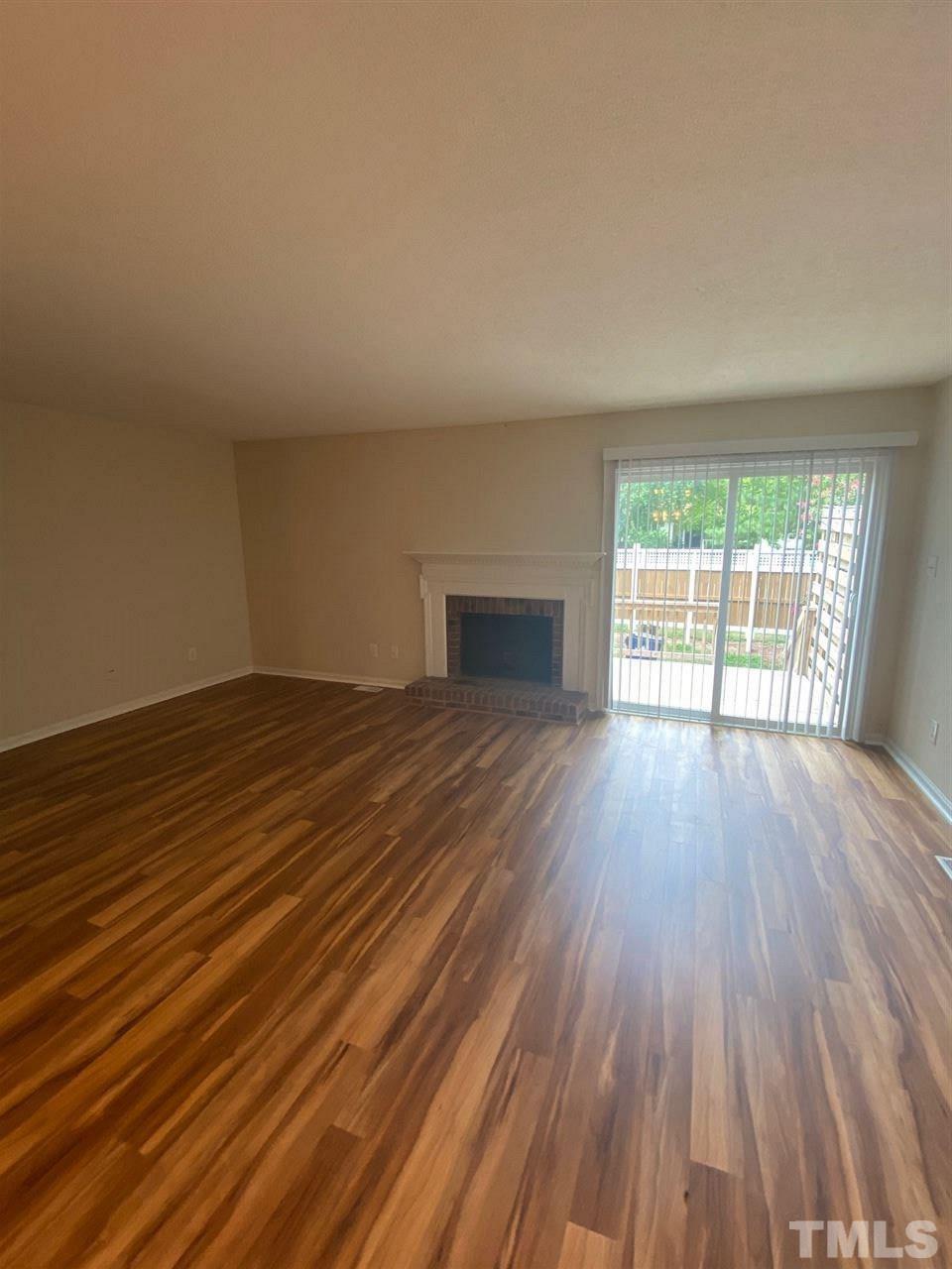 5484 Pine Top Circle Raleigh, NC 27612 - Photo 3 of 6 an empty room with wooden floor and windows