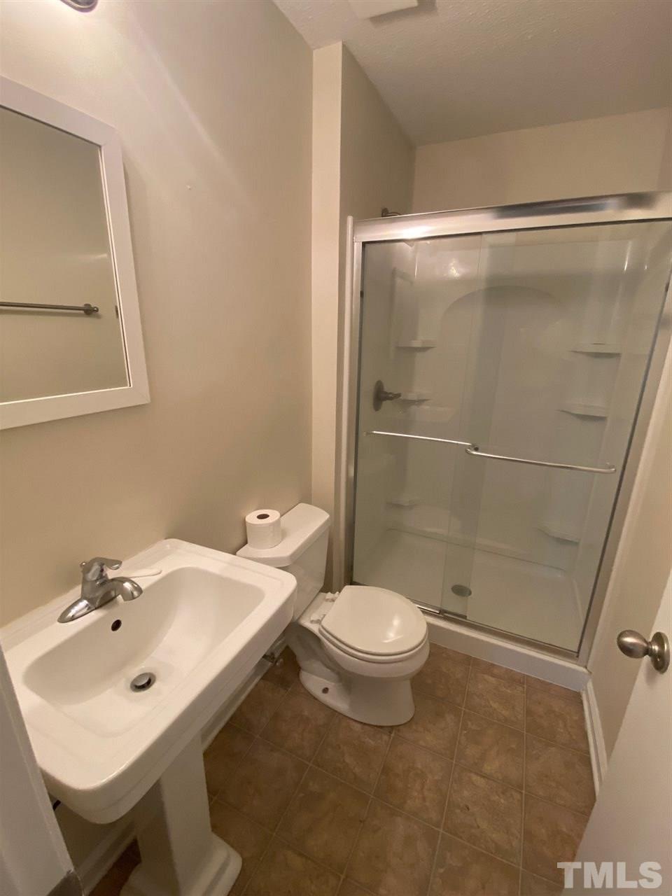 5484 Pine Top Circle Raleigh, NC 27612 - Photo 6 of 6 a bathroom with a sink toilet and shower