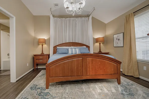a bathroom with a double vanity sink a mirror and a bathtub