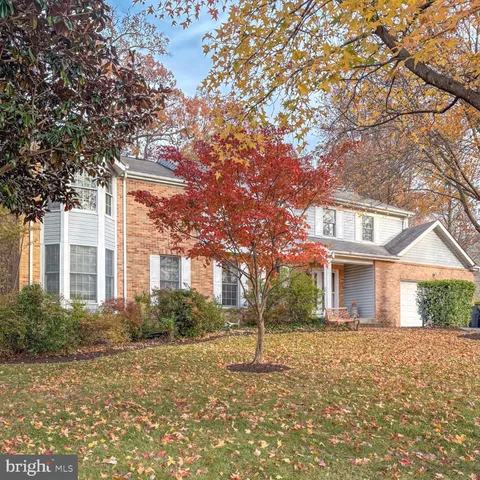 a front view of house with yard and trees around