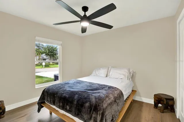 a bedroom with a bed and a large window