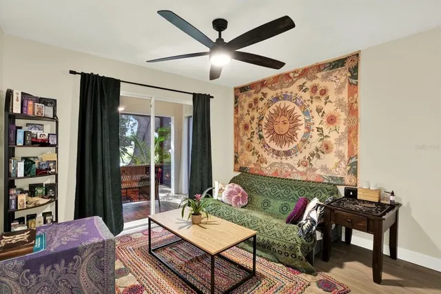 a living room with furniture and a book shelf