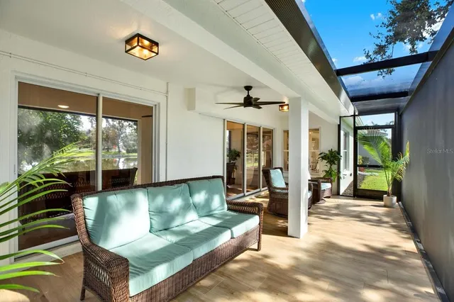 a living room with couch and a floor to ceiling window