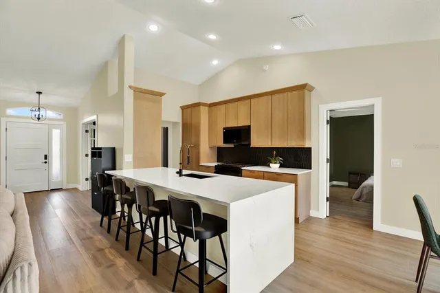 a large kitchen with a table and chairs