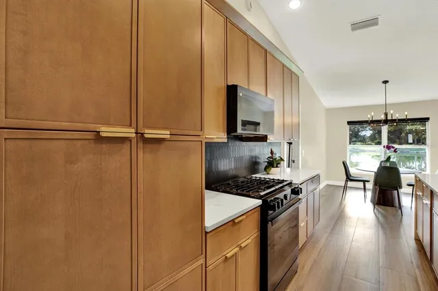 a kitchen with a refrigerator a stove top oven a sink and dishwasher