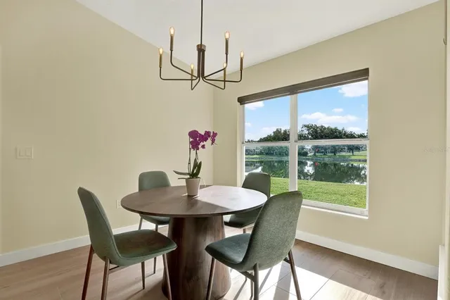 a view of a dining room with furniture window and wooden floor