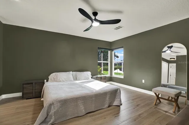 a bedroom with a bed dresser and a window