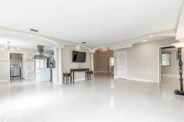 a kitchen with stainless steel appliances kitchen island granite countertop a stove and cabinets