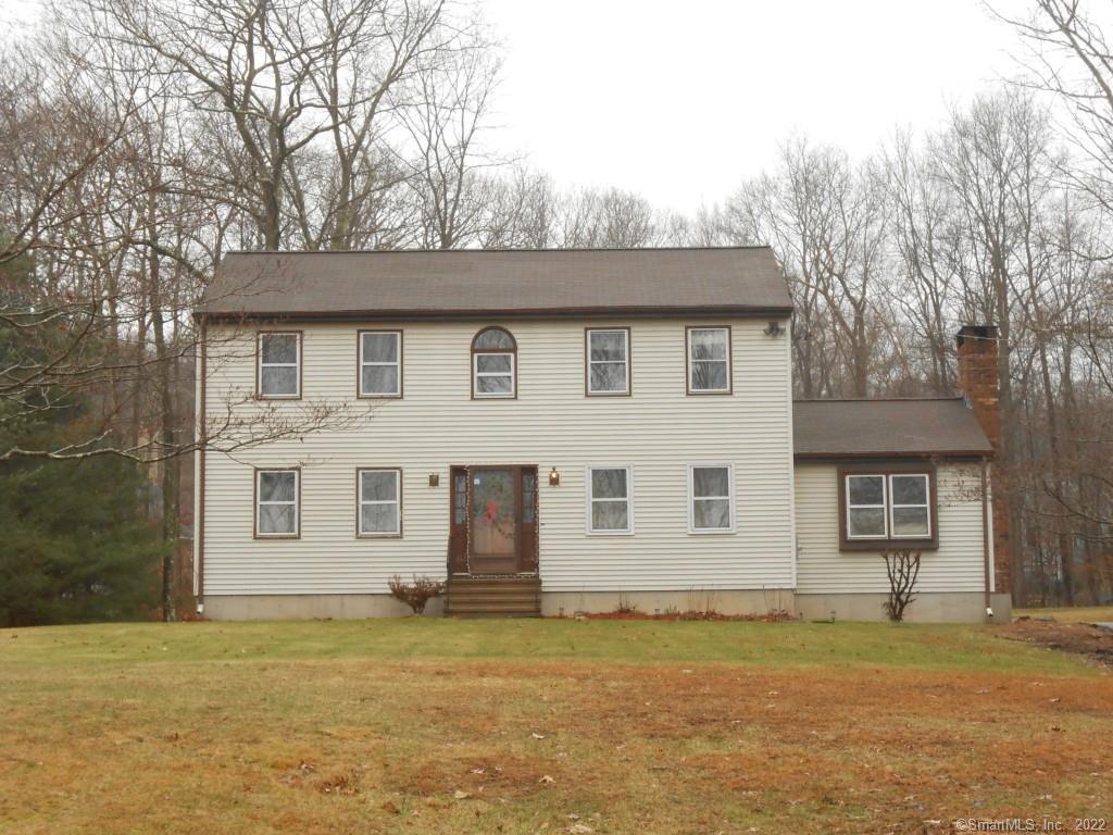a house that has a tree in front of it