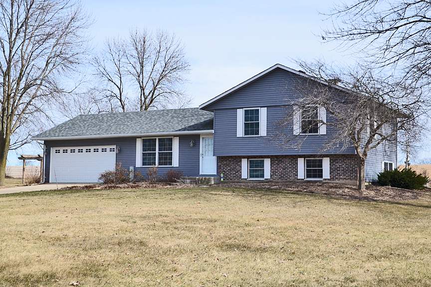 6727 Theodorff Road Pecatonica, IL 61063 - Photo 1 of 16 a front view of a house with yard and trees