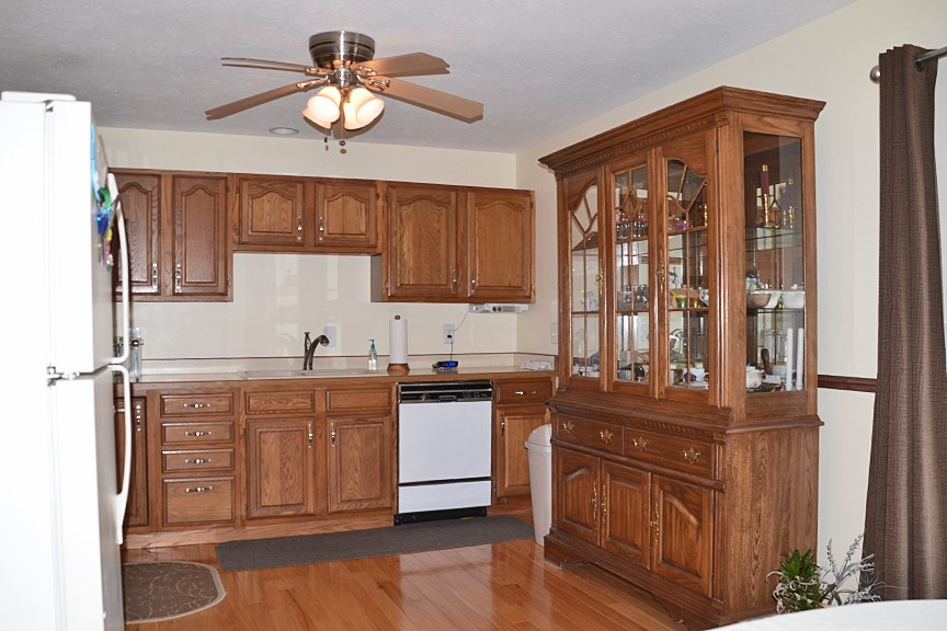 6727 Theodorff Road Pecatonica, IL 61063 - Photo 4 of 16 a kitchen with stainless steel appliances granite countertop a stove a sink dishwasher and a refrigerator with wooden floor
