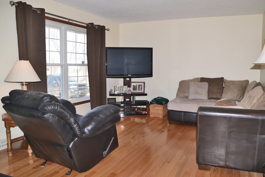 6727 Theodorff Road Pecatonica, IL 61063 - Photo 5 of 16 a living room with furniture and a flat screen tv