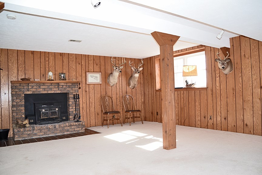 6727 Theodorff Road Pecatonica, IL 61063 - Photo 6 of 16 a view of a livingroom with a fireplace and a window