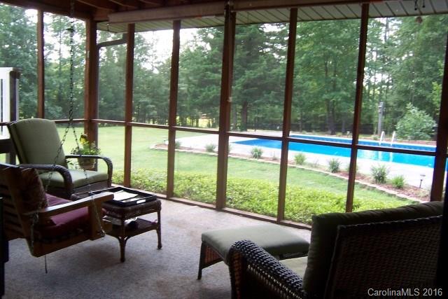 2316 Golf Course Road, Unit P8871 & P88151 Columbus, NC 28722 - Photo 11 of 21 a living room with furniture and a floor to ceiling window