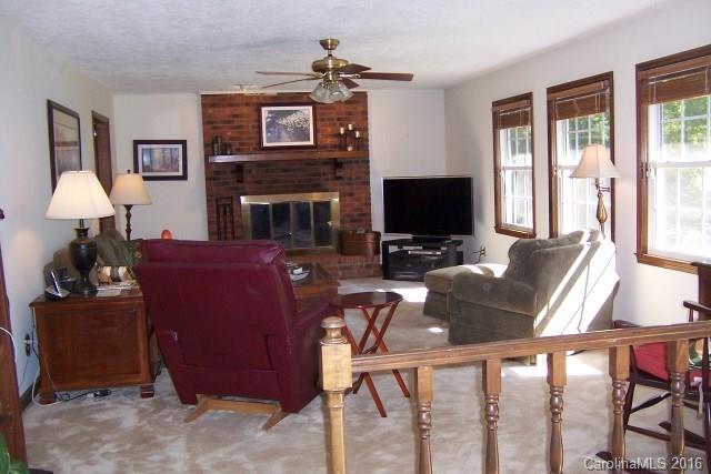 2316 Golf Course Road, Unit P8871 & P88151 Columbus, NC 28722 - Photo 12 of 21 a living room with furniture a fireplace and a flat screen tv