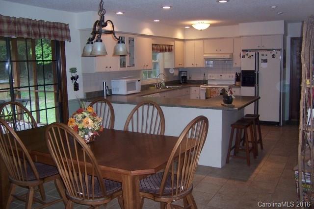 2316 Golf Course Road, Unit P8871 & P88151 Columbus, NC 28722 - Photo 16 of 21 a view of a dining room with furniture window and wooden floor