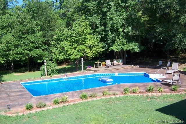 2316 Golf Course Road, Unit P8871 & P88151 Columbus, NC 28722 - Photo 7 of 21 a view of swimming pool with lawn chairs and large trees