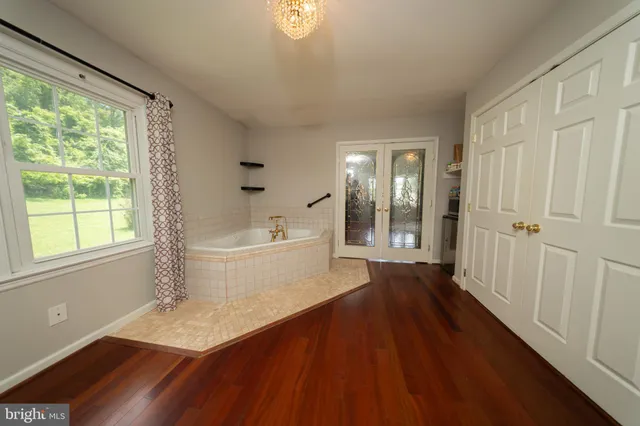 a view of a room with wooden floor and white walls