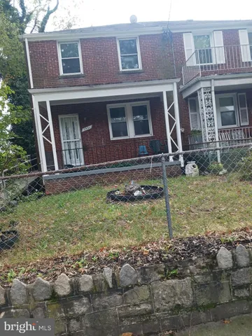 a view of a brick house with large windows
