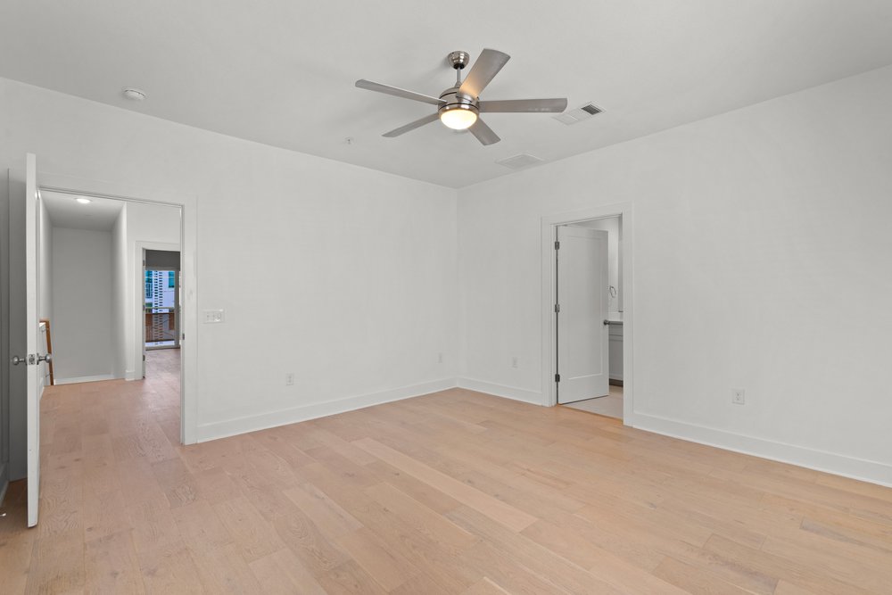 2827 Manor Road, Unit 2201 Austin, TX 78722 - Photo 33 of 40 Spacious interior room featuring light wood-finish flooring, white walls, and a modern ceiling fan with integrated lighting