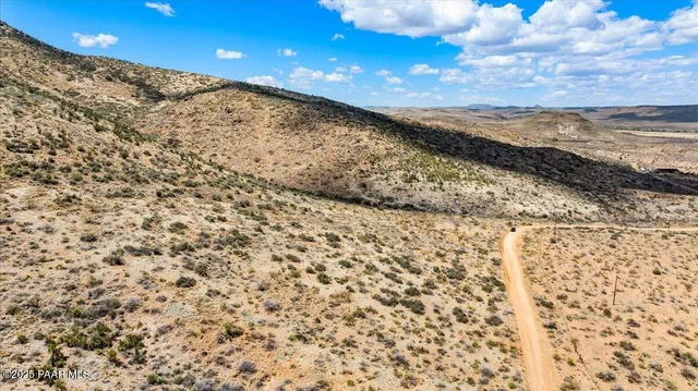 a view of a large building with mountains in the background